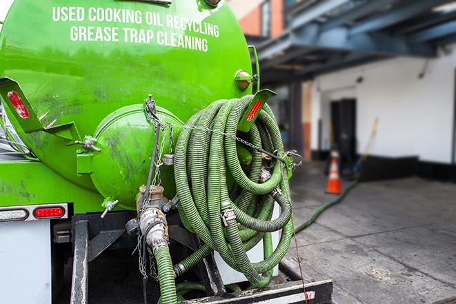 large truck pumping grease trap at a restaurant in Brighton, TN